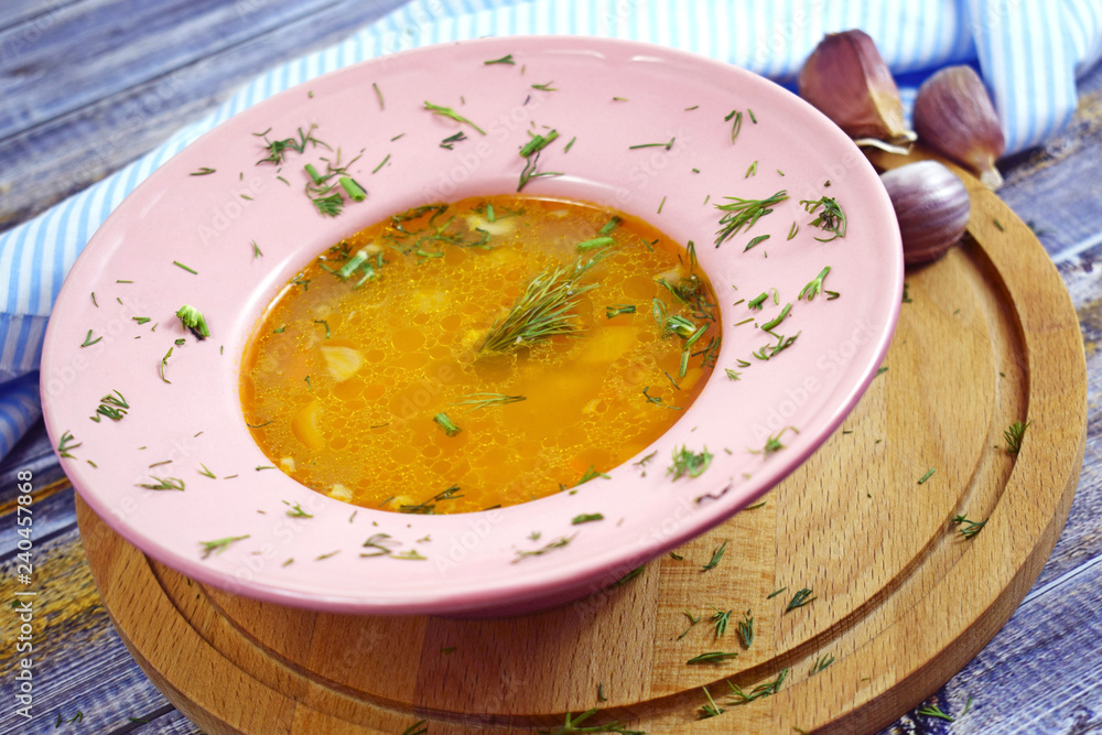 Delicious hot soup with rice, garlic and hot pepper on wooden background. Delicious hot soup with rice, garlic and hot pepper on wooden background.