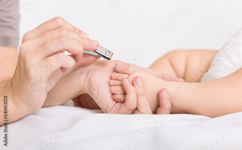 Mother cutting toenails for Baby close up
