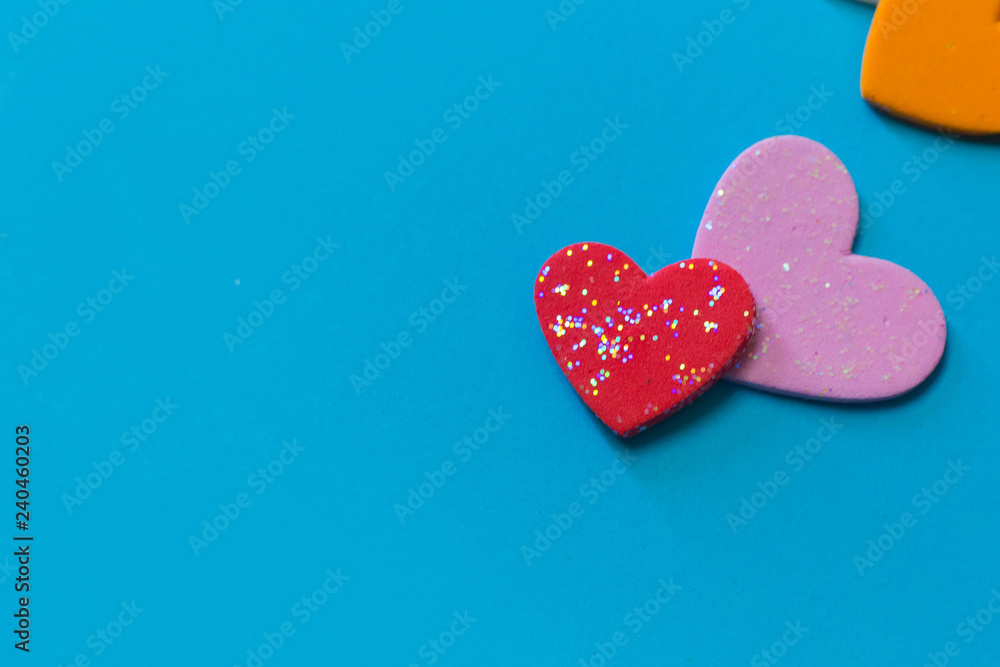 multi colour heart on blue background close up image. multi colour heart on blue background close up image.