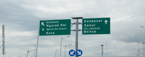 Road sign on Bali Mandara showing directions to Airport, Kuta,Denpasar, Sanur and Benoa 