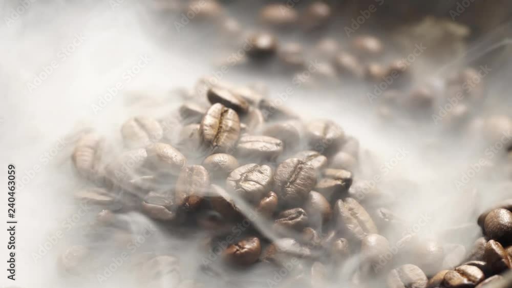 Fragrant coffee beans are roasted in a frying pan, smoke comes from coffee beans. The whole composition scrolls slowly around the camera. Fragrant coffee beans are roasted in a frying pan, smoke comes from coffee beans. The whole composition scrolls slowly around the camera.