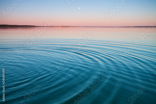 Fototapeta Naklejka Na Ścianę i Meble -  The turquoise lake at dawn.small symmetrical waves