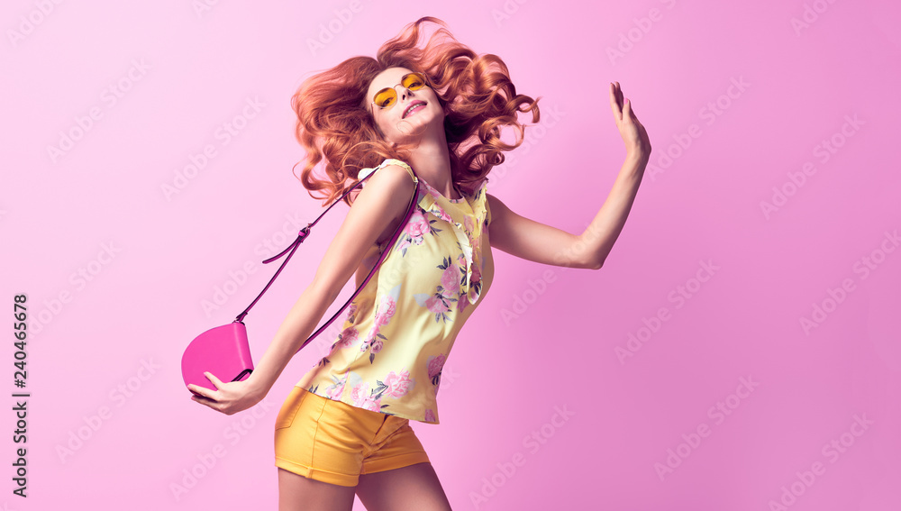 Portrait lovable woman having fun in studio wearing Stylish blouse, fashion yellow shorts, Trendy wavy hairstyle, makeup. Redhead model girl with happy positive emotion - obrazy, fototapety, plakaty 