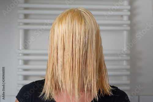 Blond woman with shoulder length wet hair