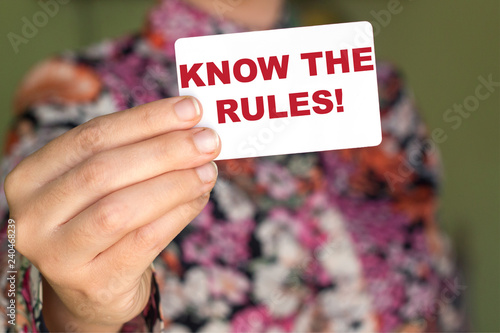 Know The Rules! on sticky note holding by woman photo