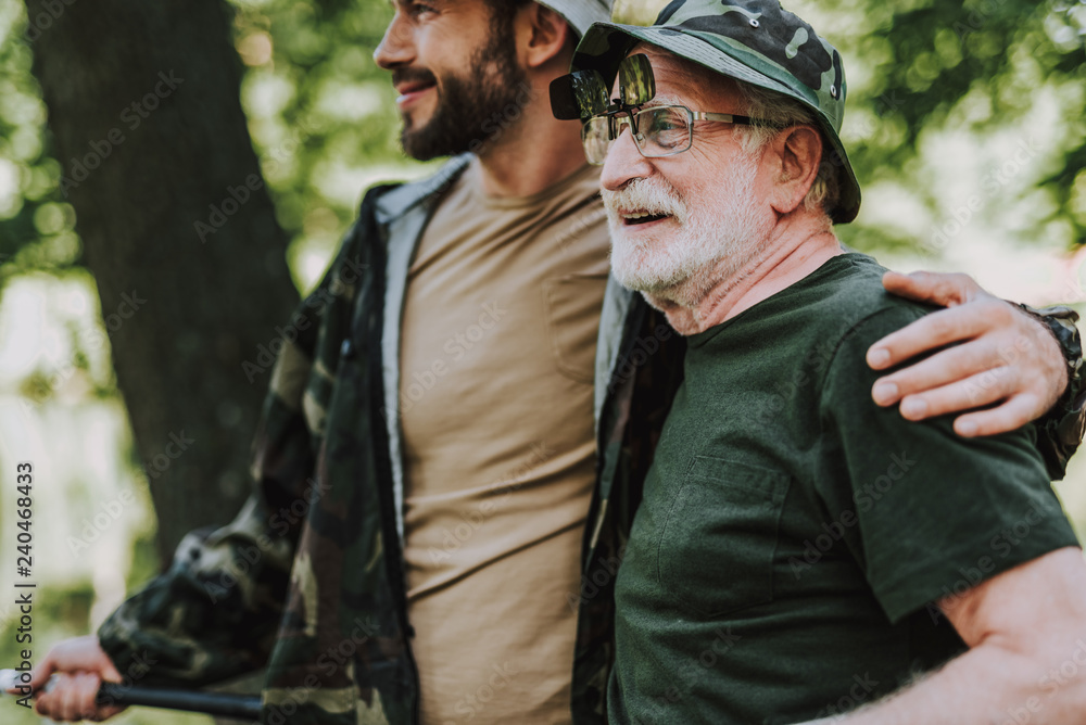Fototapeta premium Cheerful elderly man resting with his adult son