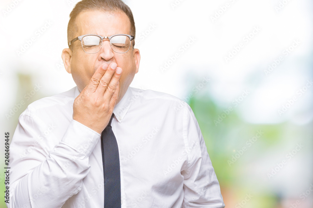 Middle age bussines arab man wearing glasses over isolated background bored yawning tired covering mouth with hand. Restless and sleepiness. Middle age bussines arab man wearing glasses over isolated background bored yawning tired covering mouth with hand. Restless and sleepiness.
