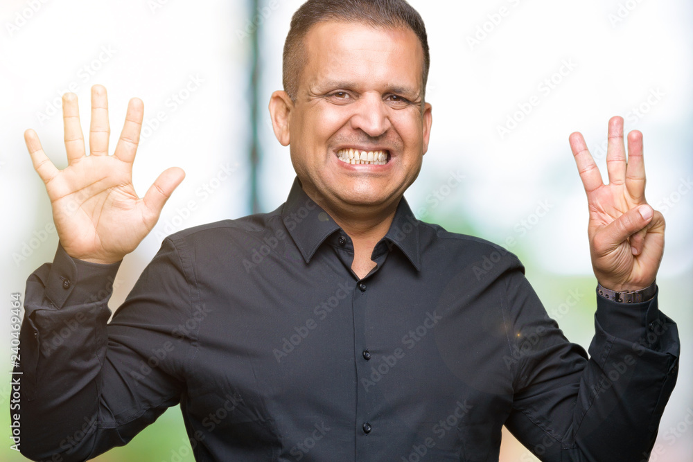 Handsome middle age arab business man over isolated background showing and pointing up with fingers number eight while smiling confident and happy. Handsome middle age arab business man over isolated background showing and pointing up with fingers number eight while smiling confident and happy.