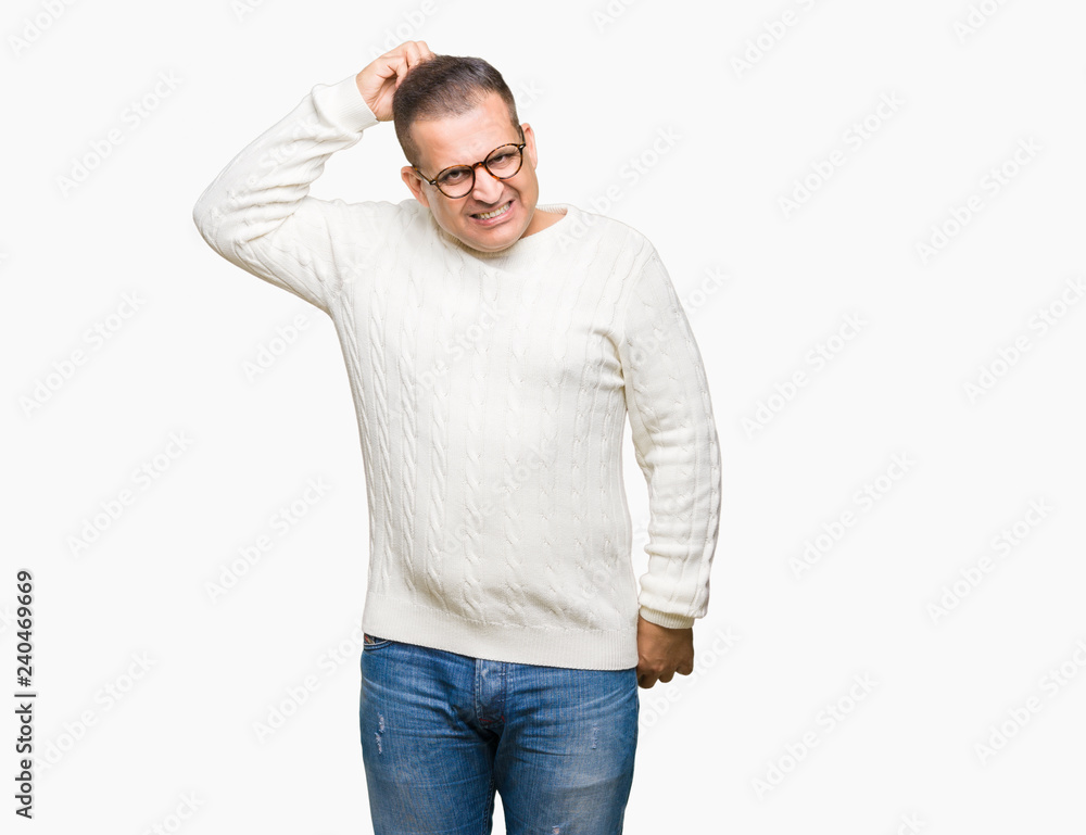 Middle age arab man wearing glasses over isolated background confuse and wonder about question. Uncertain with doubt, thinking with hand on head. Pensive concept. Middle age arab man wearing glasses over isolated background confuse and wonder about question. Uncertain with doubt, thinking with hand on head. Pensive concept.