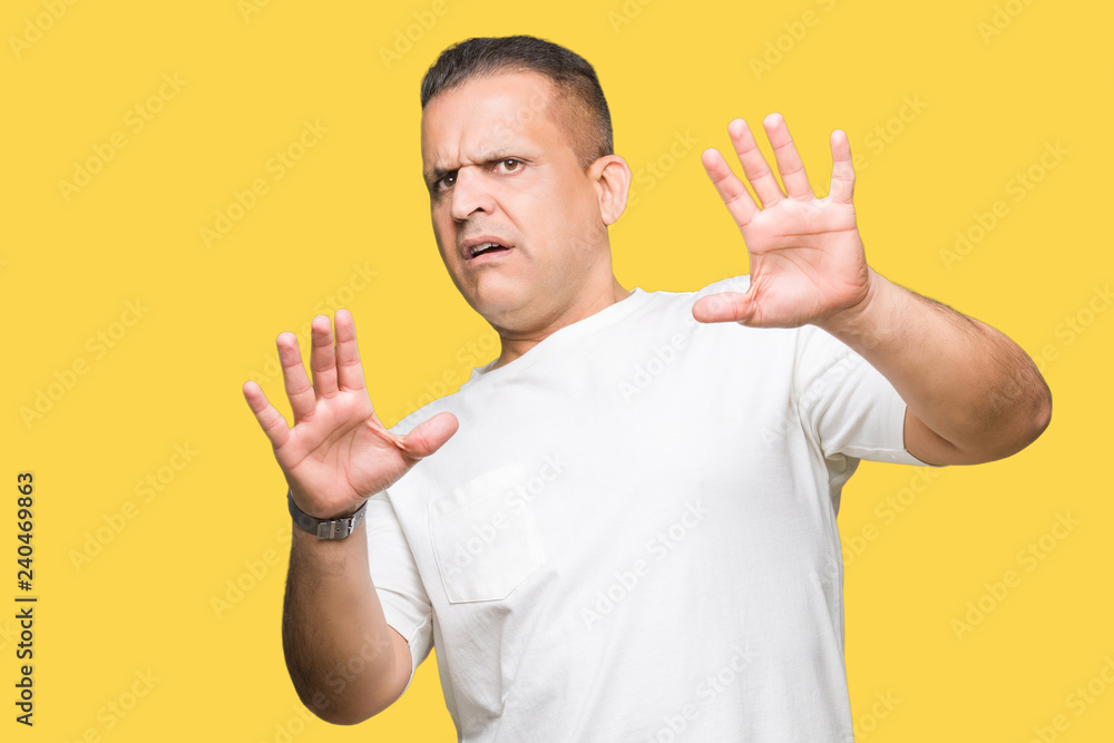 Middle age arab man wearig white t-shirt over isolated background Smiling doing frame using hands palms and fingers, camera perspective Middle age arab man wearig white t-shirt over isolated background Smiling doing frame using hands palms and fingers, camera perspective