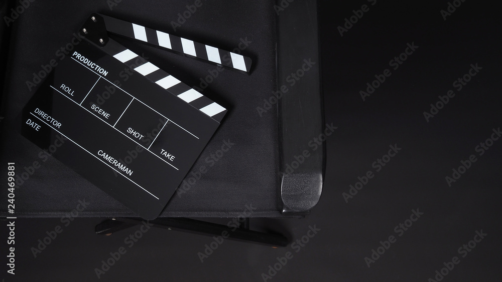 Clapperboard or clap board or movie slate with director chair use in video production ,film, cinema industry on black background.