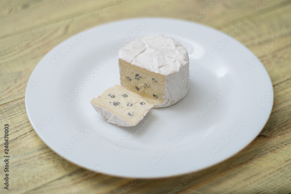 Blue cheese cut on a plate.