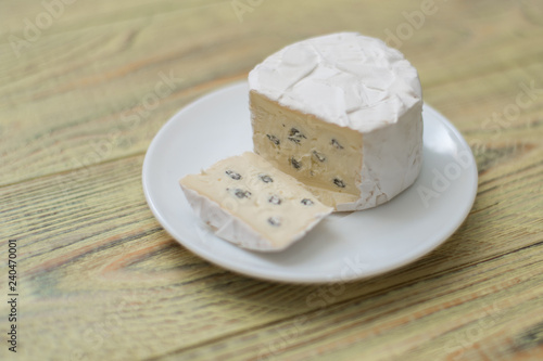 Blue cheese cut on a plate.