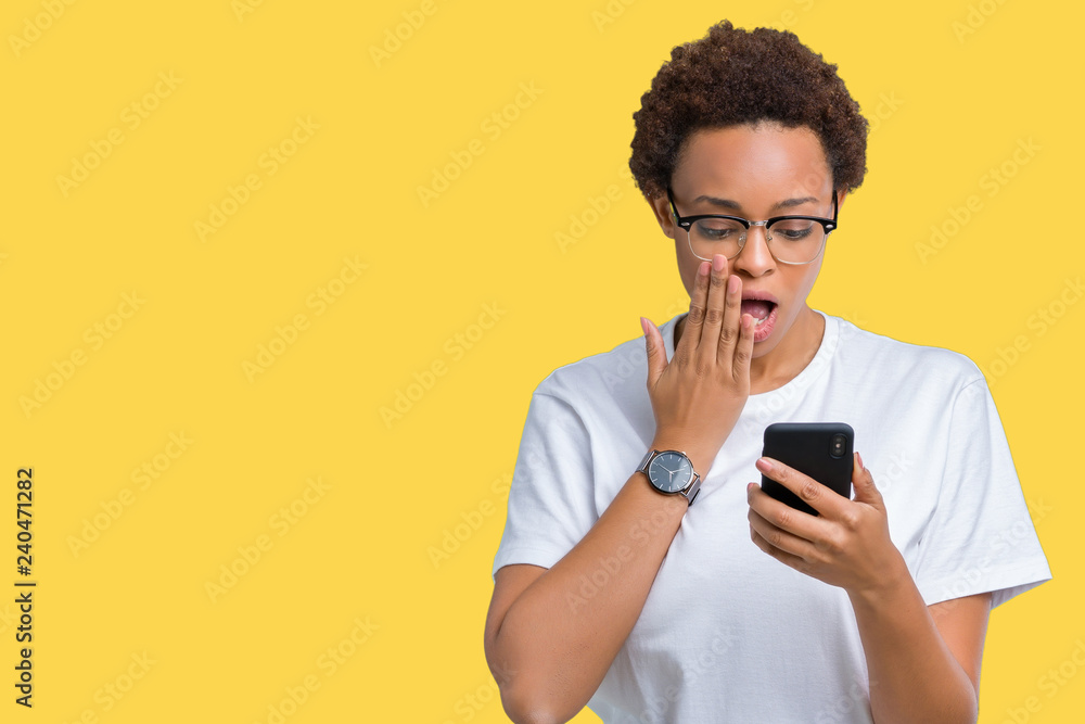 Young african american woman using smartphone over isolated background cover mouth with hand shocked with shame for mistake, expression of fear, scared in silence, secret concept Young african american woman using smartphone over isolated background cover mouth with hand shocked with shame for mistake, expression of fear, scared in silence, secret concept