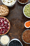 Healthy food, dieting, nutrition concept, vegan protein source. Assortment of colorful raw legumes: lentils, green peas, beans, chickpeas, rice in bowls. Background. Free space.