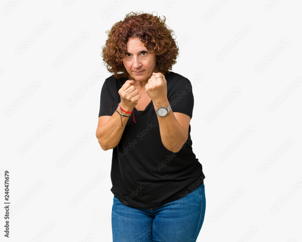 Beautiful middle ager senior woman over isolated background Ready to fight with fist defense gesture, angry and upset face, afraid of problem Beautiful middle ager senior woman over isolated background Ready to fight with fist defense gesture, angry and upset face, afraid of problem