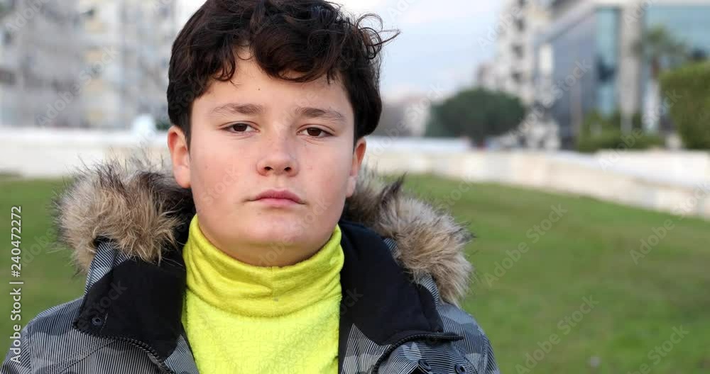 Portrait of happy little boy with winter clothes smiling at camera in park at winter time Portrait of happy little boy with winter clothes smiling at camera in park at winter time