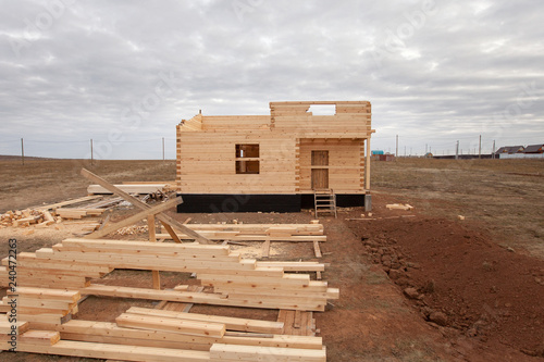 Unfinished, ecological wooden house and building area