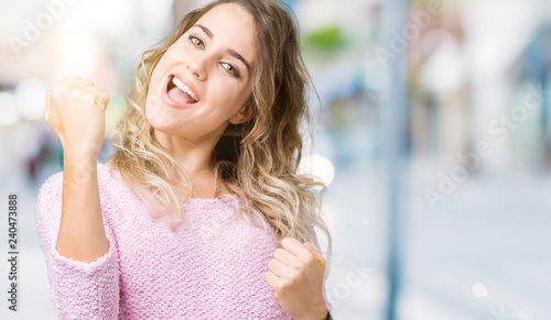 Wallpaper Mural Beautiful young blonde woman over isolated background very happy and excited doing winner gesture with arms raised, smiling and screaming for success. Celebration concept. Torontodigital.ca