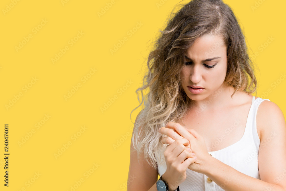 Beautiful young blonde woman over isolated background Suffering pain on hands and fingers, arthritis inflammation Beautiful young blonde woman over isolated background Suffering pain on hands and fingers, arthritis inflammation