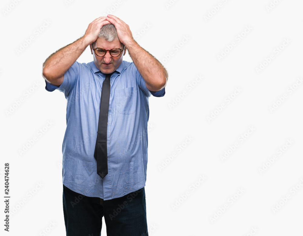Handsome senior business man over isolated background suffering from headache desperate and stressed because pain and migraine. Hands on head. Handsome senior business man over isolated background suffering from headache desperate and stressed because pain and migraine. Hands on head.