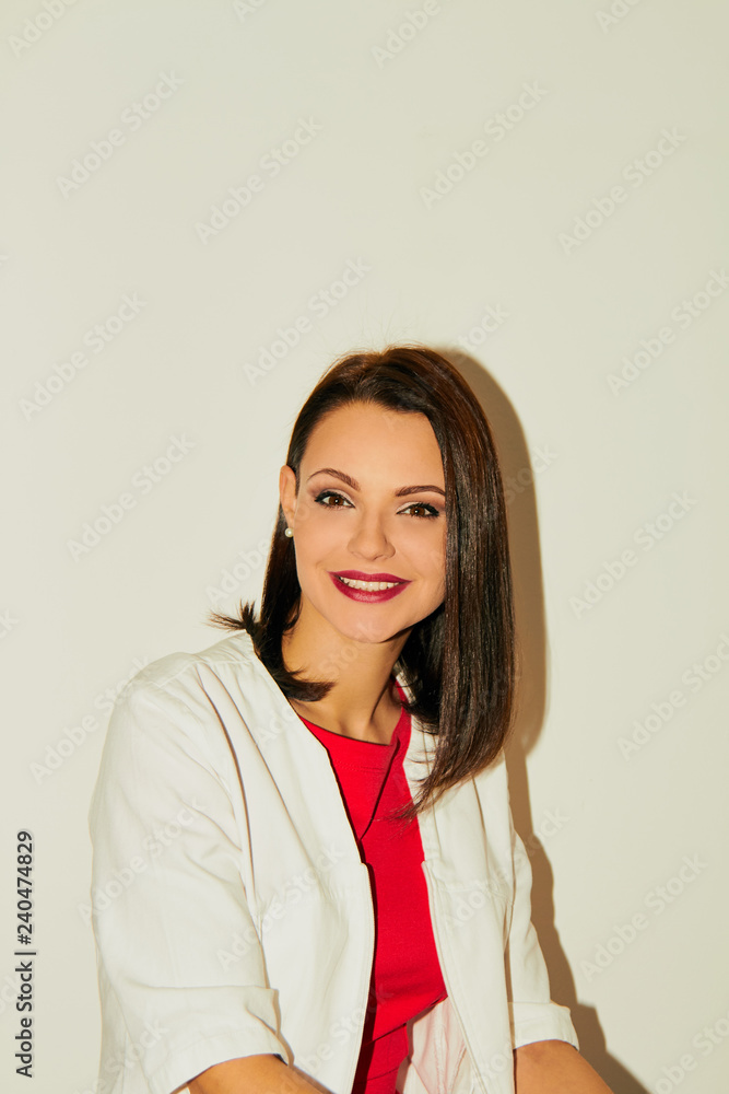 Portrait of an attractive female doctor in white coat. Portrait of an attractive female doctor in white coat.