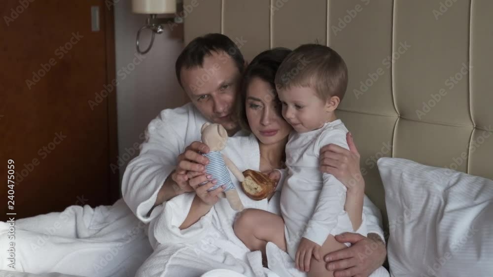 Happy family. Father, mother and son sitting on the sofa. happy moments Happy family. Father, mother and son sitting on the sofa. happy moments