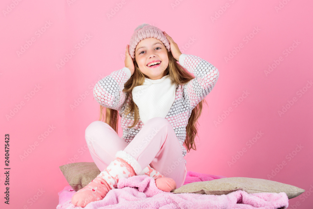 Child long hair warm woolen hat enjoy warm. Warm clothes concept. Warm accessories that will keep you cozy this winter. Keep warm and comfortable. Kid girl wear knitted hat relaxing pink background Child long hair warm woolen hat enjoy warm. Warm clothes concept. Warm accessories that will keep you cozy this winter. Keep warm and comfortable. Kid girl wear knitted hat relaxing pink background