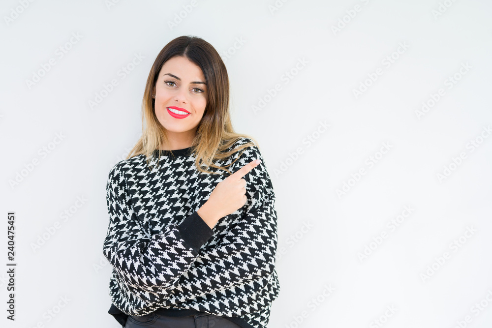 Young woman wearing casual sweater over isolated background Pointing with hand finger to the side showing advertisement, serious and calm face Young woman wearing casual sweater over isolated background Pointing with hand finger to the side showing advertisement, serious and calm face