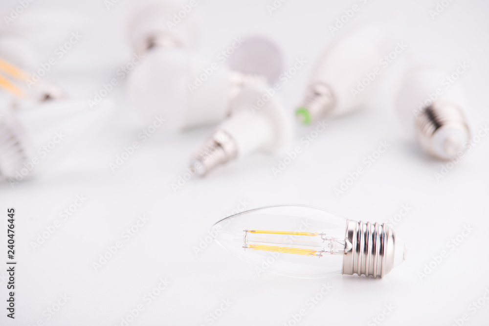 Led lamps lie on a white background. Theme energy saving in the house Led lamps lie on a white background. Theme energy saving in the house