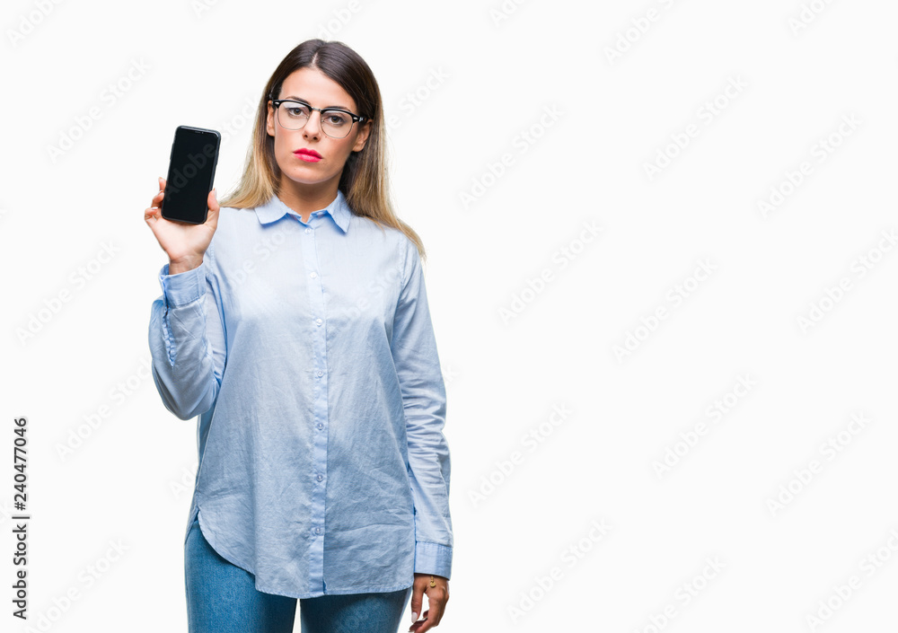 Young beautiful business woman showing blank screen of smartphone over isolated background with a confident expression on smart face thinking serious Young beautiful business woman showing blank screen of smartphone over isolated background with a confident expression on smart face thinking serious
