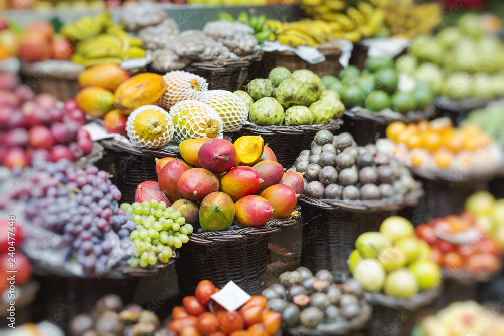 Market stall with tropical fruits and vegetables. Selective Focus.