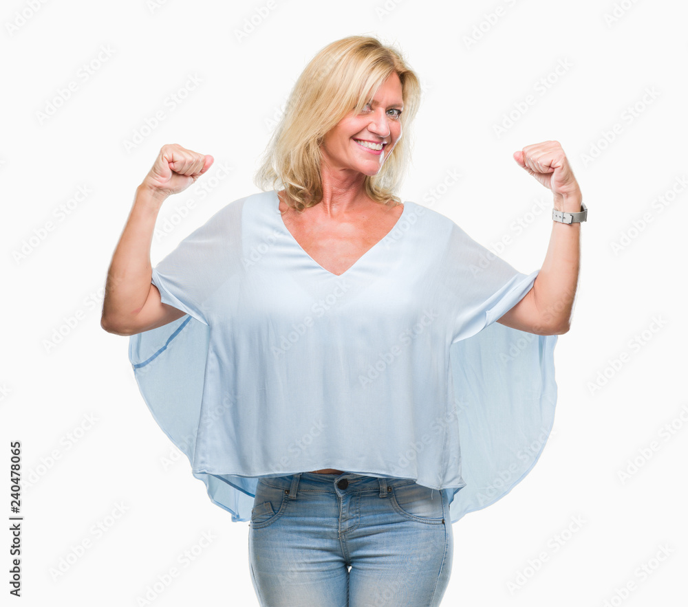 Fototapeta premium Middle age blonde business woman over isolated background showing arms muscles smiling proud. Fitness concept.