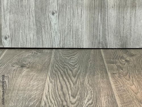 Wooden empty beige table in front of gray wooden background.