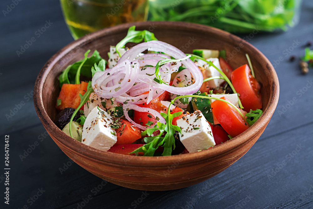 Greek salad with fresh tomato, cucumber, red onion, basil, feta cheese, black olives and Italian herbs Greek salad with fresh tomato, cucumber, red onion, basil, feta cheese, black olives and Italian herbs