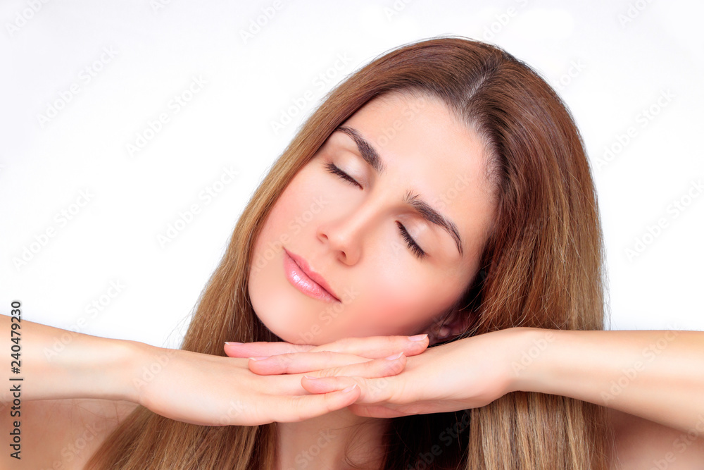 Beautiful face of a woman with closed eyes and hands under the chin Beautiful face of a woman with closed eyes and hands under the chin
