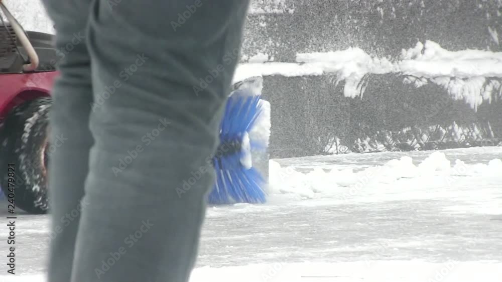 Man working with snow blower after winter storm in city Man working with snow blower after winter storm in city
