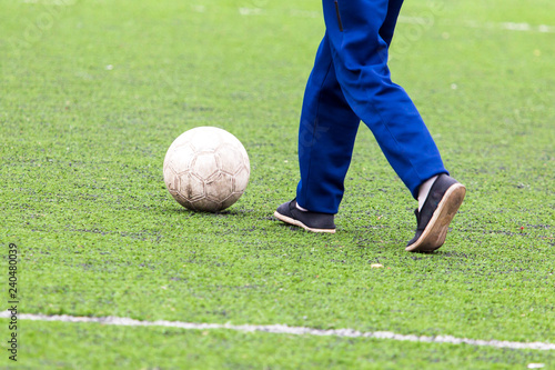 Ball on the green grass of a football field
