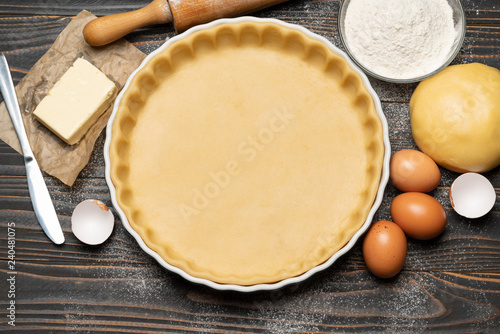 shortbread dough for baking quiche tart and ingredients in baking form photo