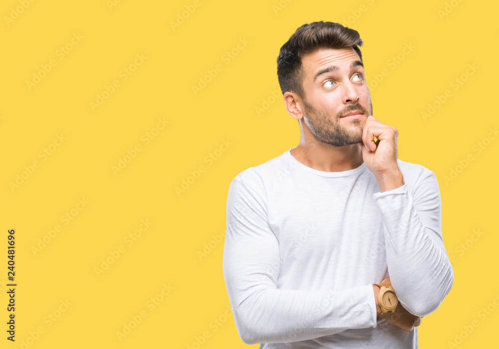 © Krakenimages.com - Young handsome man over isolated background with hand on chin thinking about question, pensive expression. Smiling with thoughtful face. Doubt concept. © Krakenimages.com - Young handsome man over isolated background with hand on chin thinking about question, pensive expression. Smiling with thoughtful face. Doubt concept.
