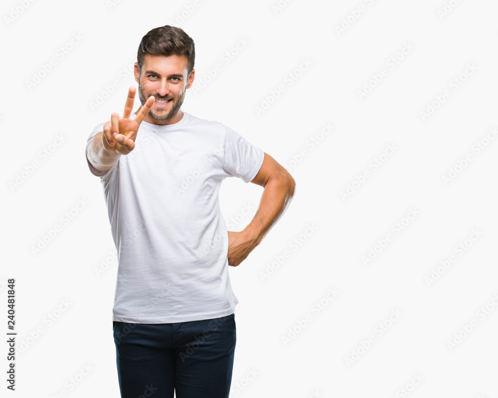 Young handsome man over isolated background smiling looking to the camera showing fingers doing victory sign. Number two.