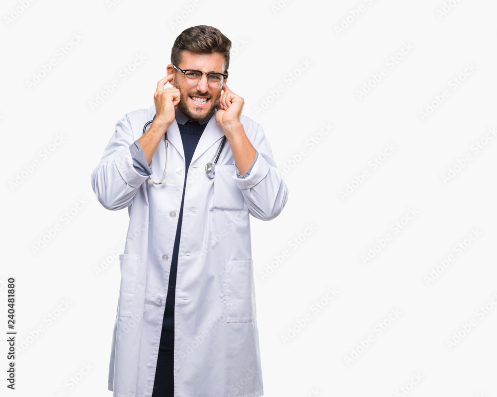Young handsome doctor man over isolated background covering ears with fingers with annoyed expression for the noise of loud music. Deaf concept. Young handsome doctor man over isolated background covering ears with fingers with annoyed expression for the noise of loud music. Deaf concept.