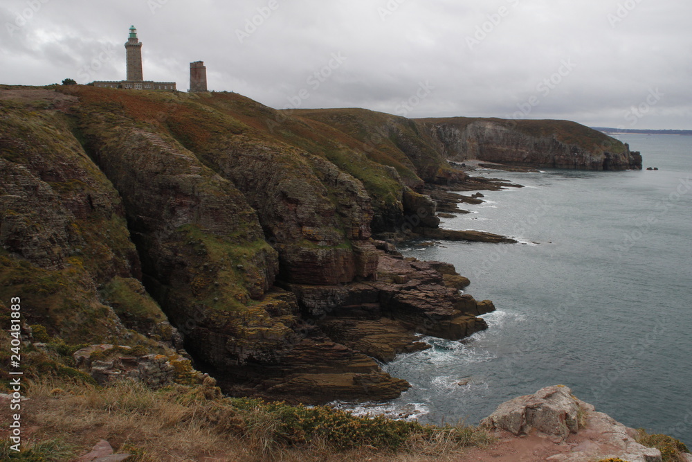 Cold northern cliffs and the Celtic Sea with a lighthouse in French Brittany Pointe du Decolle France