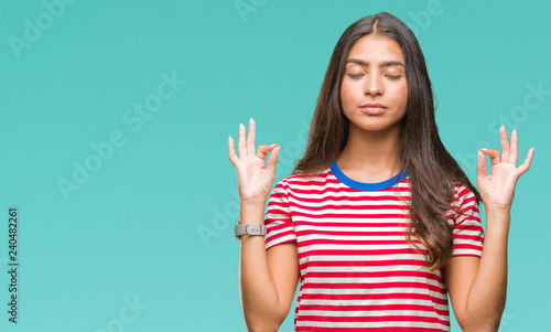 Young beautiful arab woman over isolated background relax and smiling with eyes closed doing meditation gesture with fingers. Yoga concept.