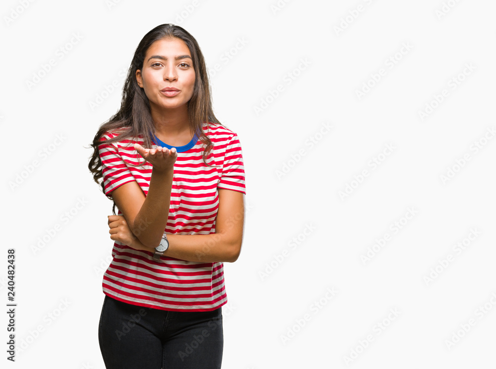 Young beautiful arab woman over isolated background looking at the camera blowing a kiss with hand on air being lovely and sexy. Love expression. Young beautiful arab woman over isolated background looking at the camera blowing a kiss with hand on air being lovely and sexy. Love expression.