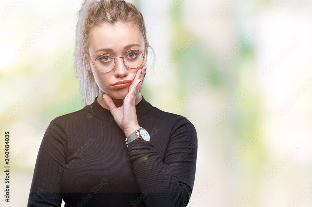 Young blonde woman wearing glasses over isolated background thinking looking tired and bored with depression problems with crossed arms. Young blonde woman wearing glasses over isolated background thinking looking tired and bored with depression problems with crossed arms.