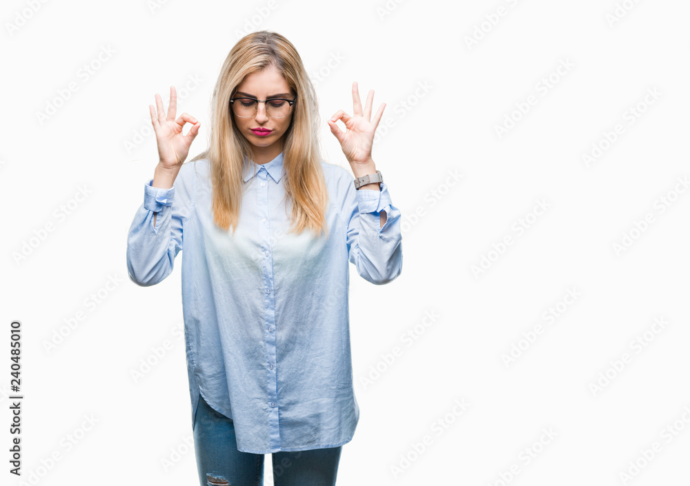 Young beautiful blonde business woman wearing glasses over isolated background relax and smiling with eyes closed doing meditation gesture with fingers. Yoga concept. Young beautiful blonde business woman wearing glasses over isolated background relax and smiling with eyes closed doing meditation gesture with fingers. Yoga concept.