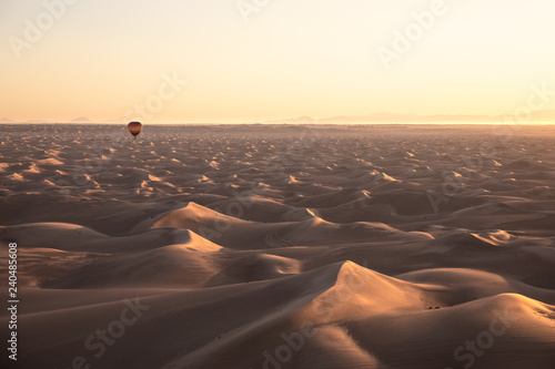 Photography Air balloons over desert during sunrise.