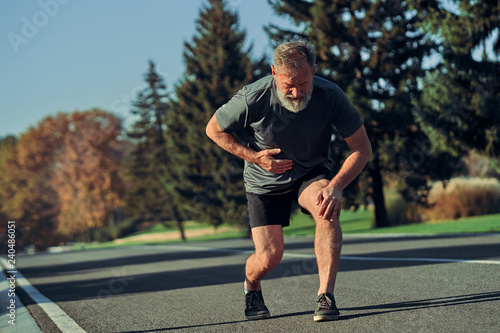 The old runner feeling bad while jogging