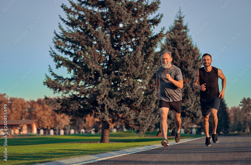 Obraz premium The father and son running on the road